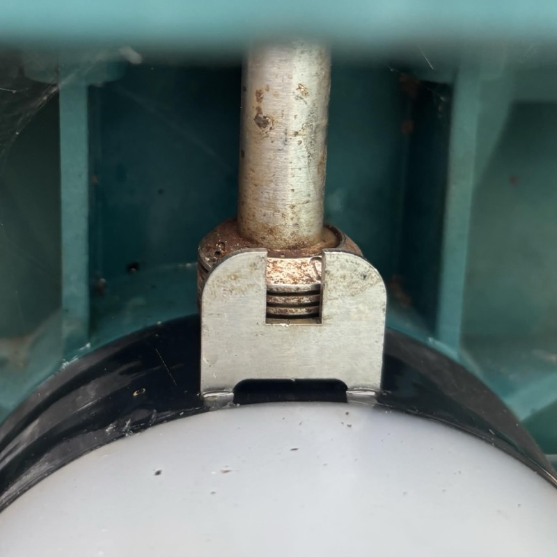 Close-up of a pump linkage pin during service