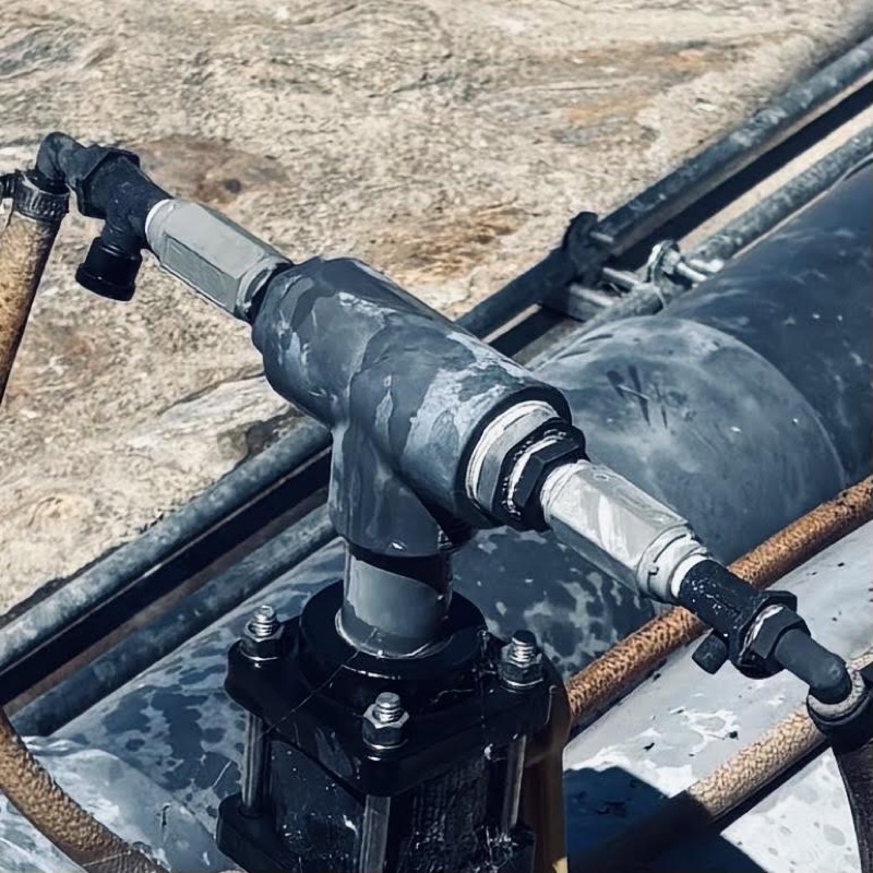 Injection tee and check valve plumbed into a supply line